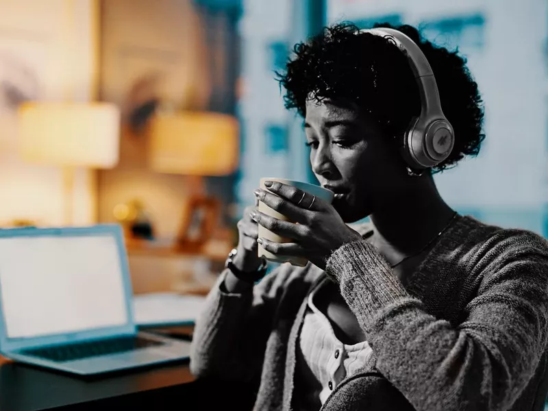 Woman drinking coffee during late night