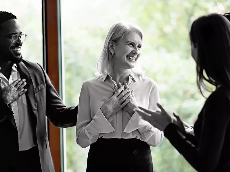 Middle-aged businesswoman getting compliments