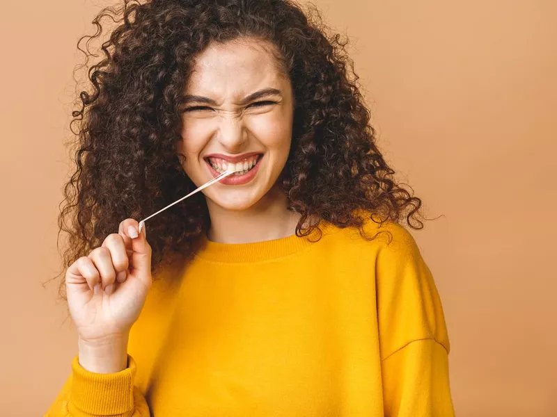 Young lady playing with gum