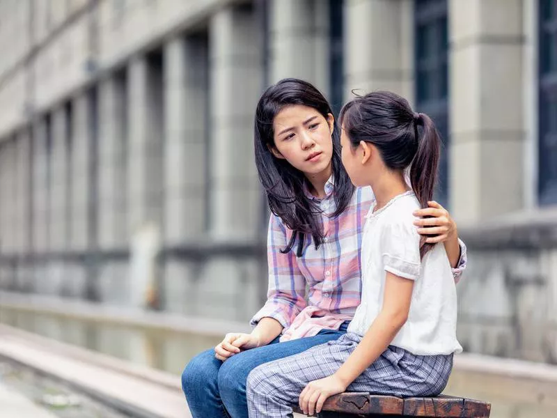 A mother having a serious talk with her daughter