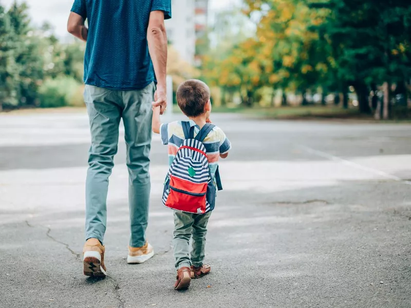 Father and son going to kindergarten.