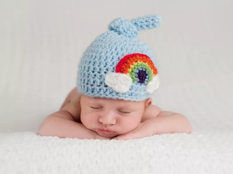 Newborn Baby Boy Wearing a Rainbow Hat