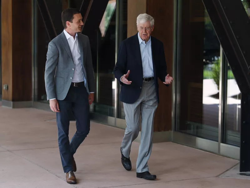 Charles Koch and Brian Hooks walking