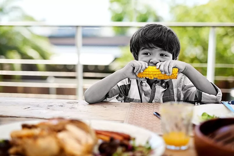 boy eating corn