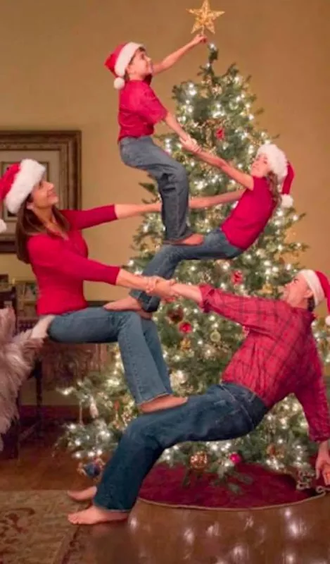 Family topping the tree with a star