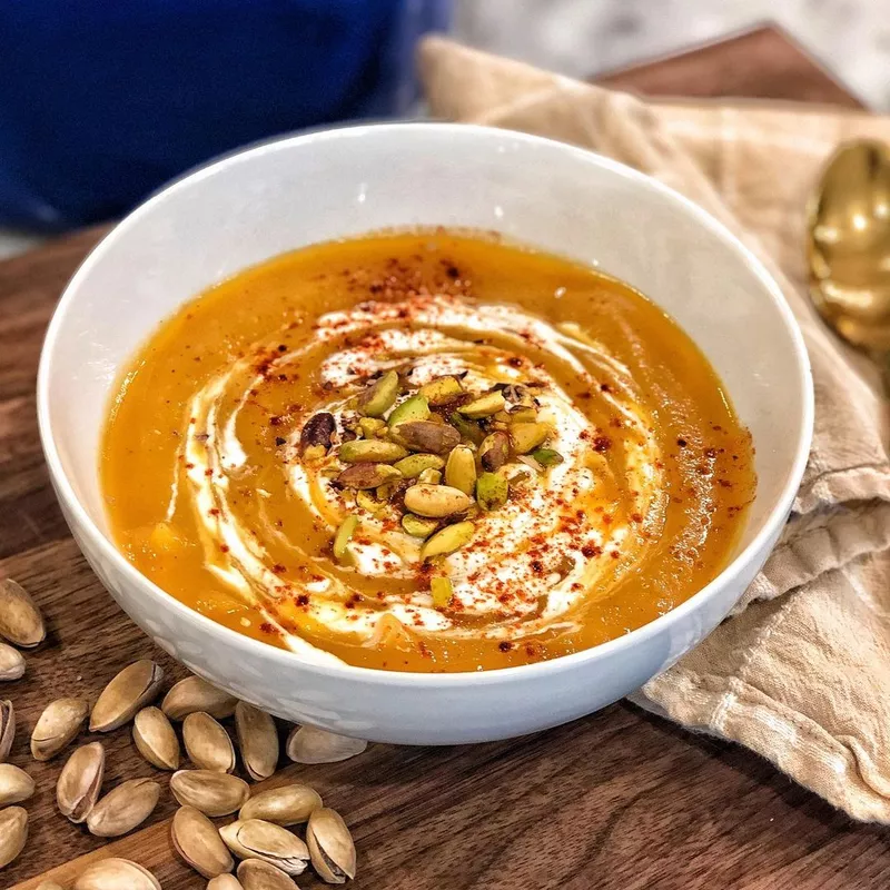 Butternut squash soup with sour cream and pistachios