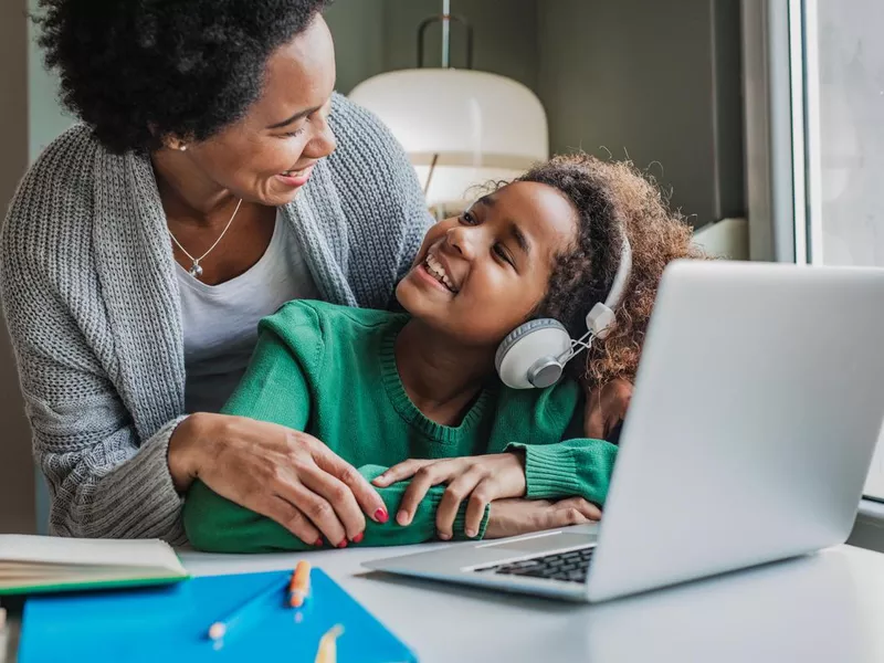 Mother helps her daughter study at home