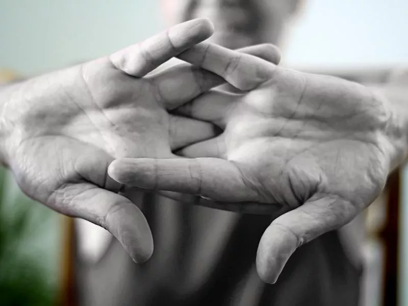 Older woman cracking their knuckles