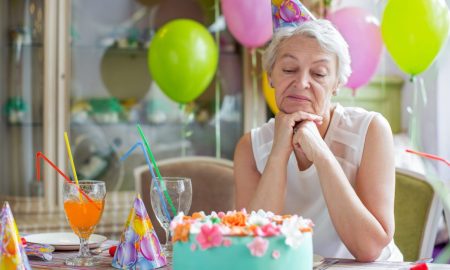 Sad elderly woman at a birthday party